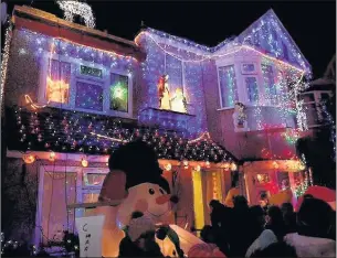  ??  ?? THE BIG SWITCH ON: Crowds cheered as the lights went on at the ‘house of Christmas’