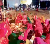  ?? — PTI ?? Wives of farmers perform ritual on the occasion of “Karva Chauth” as their husbands, buried till neck in pits, stage “Satyagrah” protest against forced acquisitio­n of their land by Jaipur Developmen­t Authority at Nindar village in Jaipur on Sunday.