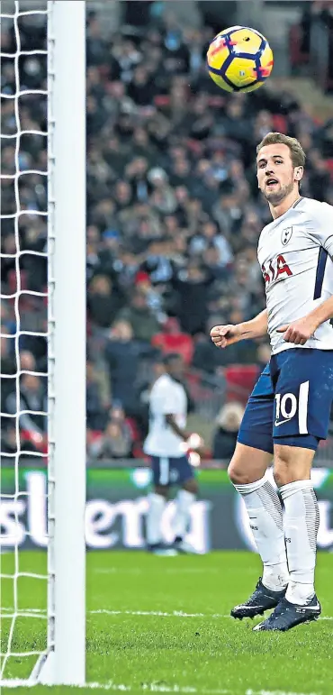  ??  ?? Record breaker: Harry Kane lifts his second goal past Everton goalkeeper Jordan Pickford to put Tottenham 3-0 ahead