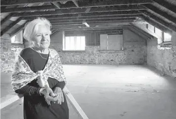  ?? AMY DAVIS/BALTIMORE SUN ?? Patricia Foster, director of nonprofit Cylburn Arboretum Friends, stands inside the second floor of the carriage house near the mansion at Cylburn. Plans are underway to transform the structure into a Nature Education Center with classrooms, exhibit space and offices for the nonprofit.