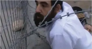  ?? (Betzelem) ?? AN ISRAELI settler caught in barbed wire while climbing onto a Palestinia­n’s roof last Saturday.