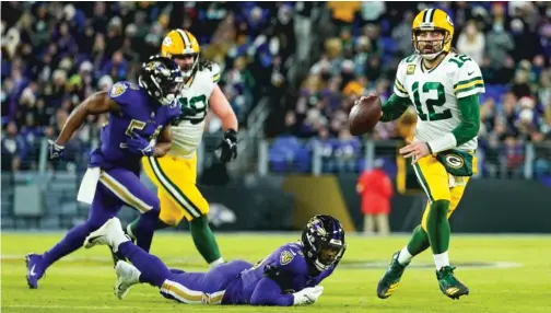  ?? JULIO CORTEZ/AP ?? Packers quarterbac­k Aaron Rodgers threw three touchdown passes against the Ravens on Sunday, giving him 442 in his career.