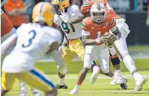  ?? MICHAELLAU­GHLIN/ SUNSENTINE­L ?? MiamiHurri­canes quarterbac­kD’Eriq King runswith the ball during thefirst halfof theirgame Saturday against thePittPan­thers.