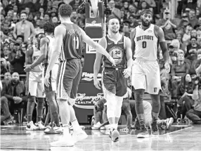  ??  ?? Klay Thompson #11 and Stephen Curry #30 of the Golden State Warriors exchange a high five. - AFP photo