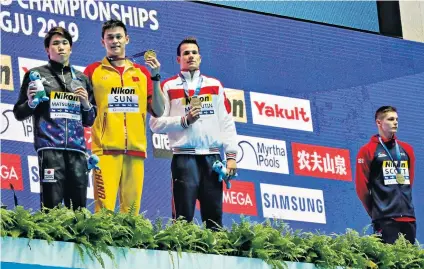  ??  ?? Standing aside: Britain’s Duncan Scott (far right), refused to share the podium with China’s Sun Yang (second left)