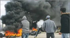  ?? AP/NASSER NASSER ?? Palestinia­n protesters clash with Israeli troops Thursday in the West Bank city of Ramallah following protests against U.S. President Donald Trump’s decision to recognize Jerusalem as the capital of Israel.