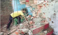  ?? REUTERS ?? A villager clears debris from his house, which was damaged by shelling by Pakistan, Trewa, Jammu, October 7