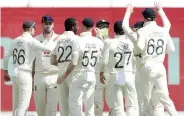  ??  ?? England players celebrate the fall of a India wicket