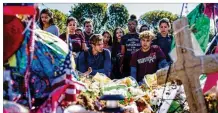  ?? SAUL MARTINEZ/NEW YORK TIMES ?? PARKLAND, FLA. Students from West Glades Middle School, next to Marjory Stoneman Douglas High, honor victims.
