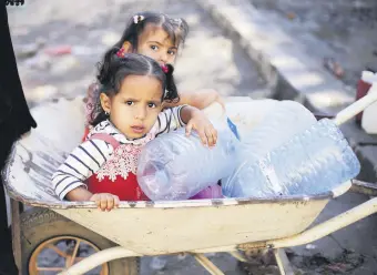  ??  ?? Girls wait to collect drinking water from a tap provided by a charity amid fears of a new cholera outbreak in Sanaa, Yemen Nov. 5.