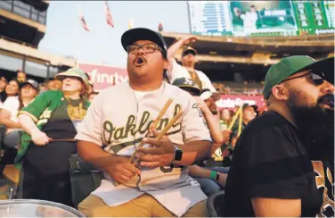  ?? Photos by Scott Strazzante / The Chronicle ?? A’s fan Bryanne Aler-Ningas of Pittsburg cheers on the team from the Coliseum bleachers last week.