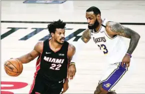  ?? GETTY IMAGES/AFP ?? Jimmy Butler (left) scored 40 points, pulled down 11 rebounds and dished out 13 assists to power the Heat past LA in game 3 of the NBA finals.