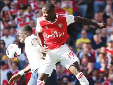  ??  ?? Arsenal’s Nicolas Pepe (right), fights for the ball with Tottenham’s Moussa Sissoko during their English Premier League soccer match between Arsenal
and Tottenham Hotspur at the Emirates Stadium in London on Sept 1. (AP)