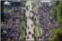  ?? YUI MOK/PA VIA AP ?? Spectators gather along the Long Walk ahead of the wedding of Prince Harry and Meghan Markle at Windsor castle in Windsor near London, England.