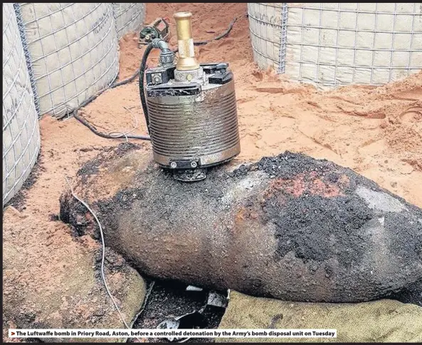  ??  ?? > The Luftwaffe bomb in Priory Road, Aston, before a controlled detonation by the Army’s bomb disposal unit on Tuesday