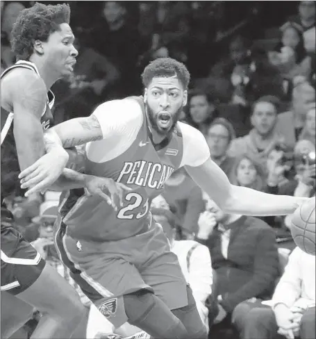  ?? Frank Franklin II Associated Press ?? ANTHONY DAVIS, driving past Brooklyn’s Ed Davis during a game in January, was not only one of the NBA’s top scorers and rebounders during his seven seasons with New Orleans, but the 6-10 forward-center also was a regular on the league’s all-defensive teams.