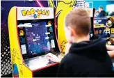  ?? AFP ?? A boy plays the ‘Pacman’ retro game at the Gamescom gaming fair, the largest in Europe.