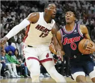  ?? MARTA LAVENDER - THE ASSOCIATED PRESS ?? Tyrese Maxey (0) drives to the basket as Miami Heat center Bam Adebayo (13) defends, during the first half of Game 2 of an NBA basketball second-round playoff series, Wednesday.