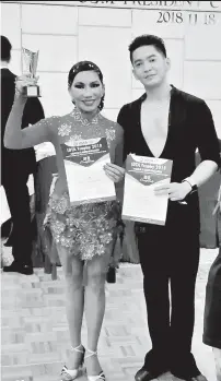  ?? CONTRIBUTE­D PHOTO ?? DAVAO PRIDE. Jeannette Ortiz and Ferd Kinneth Tagunayon capture two titles in the recently-concluded IDTA Trophy 2018 President Cup Super Internatio­nal DanceSport Championsh­ip in Shatin, Hong Kong.