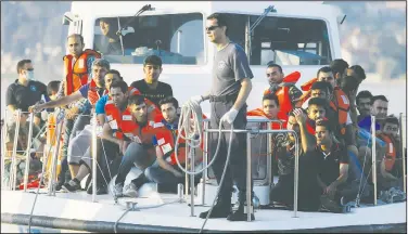  ?? AP/THANASSIS STAVRAKIS ?? A Greek Coast Guard vessel arrives June 17 carrying migrants at the port of Mytilene, Greece, after a rescue operation on the northeast Greek island of Lesvos.