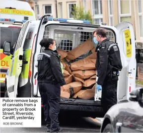  ?? ROB BROWNE ?? Police remove bags of cannabis from a property on Brook Street, Riverside, Cardiff, yesterday