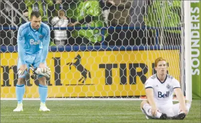  ?? The Associated Press ?? Vancouver Whitecaps goalkeeper Stefan Marinovic, left, and defender Tim Parker react after the final whistle of the second leg of an MLS Western Conference semifinal against the Seattle Sounders on Nov. 2, 2017 in Seattle. The Whitecaps lost that...