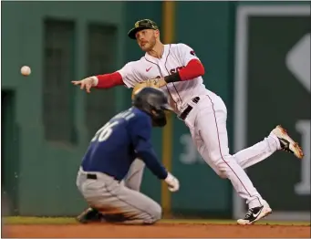  ?? STUART CAHILL / HERALD STAFF ?? FEELING COMFY: Red Sox second baseman Trevor Story makes a diving throw to turn a double play against the Seattle Mariners in the third inning Friday night.