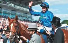  ?? Rex Features ?? Shaikh Hamdan welcomes the winner William Buick and Masar at the Epsom Racecourse, yesterday