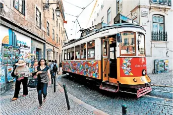  ?? DOMINIC ARIZONA BONUCCELLI/RICK STEVES’ EUROPE ?? Lisbon’s classic trolley cars — which offer a quintessen­tial Portuguese experience — can get quite crowded.