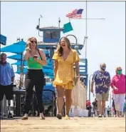  ?? Allen J. Schaben Los Angeles Times ?? BEACHGOERS IN San Clemente on Wednesday. Health officials encourage “socializin­g in a safe way.”