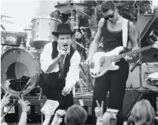  ?? Fred Larson / The Chronicle 1987 ?? U2 singer Bono and bassist Adam Clayton play their free 1987 show in Justin Herman Plaza. It was arranged in one day.