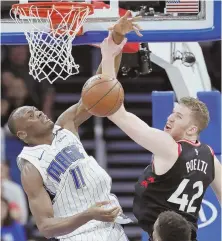  ?? AP PHOTO ?? UP IN ARMS: Orlando’s Bismack Biyombo and Toronto’s Jakob Poeltl battle for a loose rebound during their game last night in Orlando, Fla.