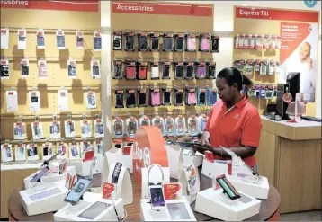  ??  ?? An employee cleans cellphone accessorie­s at a Vodacom shop in Johannesbu­rg. Vodacom shares recovered yesterday after taking a knock on Wednesday over alleged competitio­n transgress­ions.