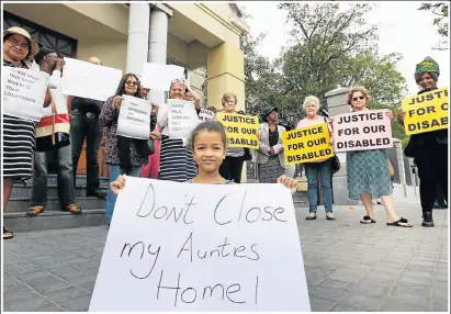  ?? Picture: EUGENE COETZEE ?? HAVE MERCY: Families of frail care patients and their supporters protest outside the high court in Port Elizabeth yesterday. In front is five-year-old Hadassah Ownhouse with a poster about her aunt, who is in frail care