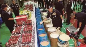  ?? FILE PIC ?? The drugs and equipment seized from the drug lab in Bukit Tengah, Penang, on Wednesday.