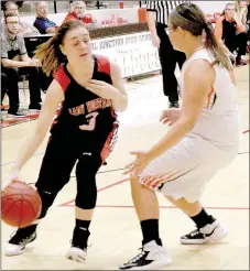  ?? PHOTO BY RICK PECK ?? McDonald County’s Samantha Frazier drives past Jasper’s Katelyn Dockery during the Lady Mustangs’ 46-23 on Monday night in the Carl Junction Tournament.