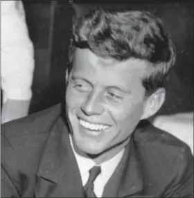  ?? FILE — THE ASSOCIATED PRESS ?? In this file photo, U.S. Navy Lt. John F. Kennedy smiles at the Stork Club in New York. A diary written by Kennedy in 1945 during his brief stint as a journalist after World War II is being auctioned on by RR Auction in Boston.