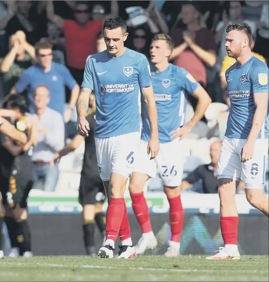  ?? Picture: Joe Pepler ?? dejected while Cambridge United celebrate their first-half opener at Fratton Park on Saturday