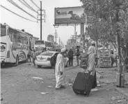  ?? AFP VIA GETTY IMAGES ?? People prepare to board a bus leaving Sudan’s capital, Khartoum, Monday as fighting between the army and paramilita­ry forces continues.