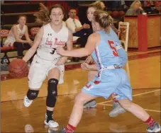  ?? RICK PECK/SPECIAL TO MCDONALD COUNTY PRESS ?? McDonald County’s Sam Frazier tries to get past Webb City’s Ali Vanzant during the Lady Mustangs’ 52-28 loss on Dec. 11 at MCHS.