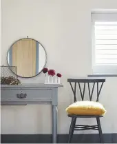  ??  ?? Main bedroom A repainted vintage table is decorated with trinkets and a mirror. Cushion, Bronte by Moon. Shutters, Blinds 2000. Round mirror, Rockett St George.