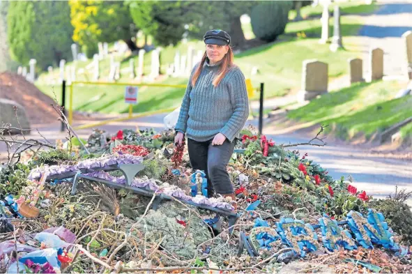  ??  ?? Sarah Proctor, at Balgay Park beside the cemetery, is highlighti­ng the large number of plastic flowers and wreaths going to landfill.