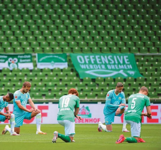  ??  ?? ABOVE: Players of Werder Bremen and Wolfsburg ‘take a knee’ prior to a German Bundesliga match in solidarity with Black Lives Matter protests across the United States over the death of George Floyd at the hands of police. Going down on one knee was first popularise­d by Colin Kaepernick during the national anthem while playing American Football for the San Francisco 49ers. He was eventually released by the team after his move caused controvers­y.