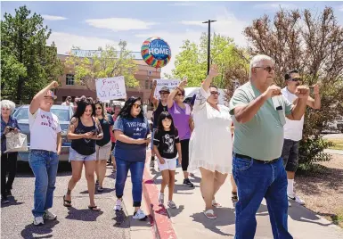  ?? ROBERTO E. ROSALES/JOURNAL ?? Friends and family of Deborah and Rudy Lucero cheer as Rudy emerges from the Kindred Long-Term Acute Care Hospital on June 23. He had been hospitaliz­ed since January after being diagnosed with COVID-19.