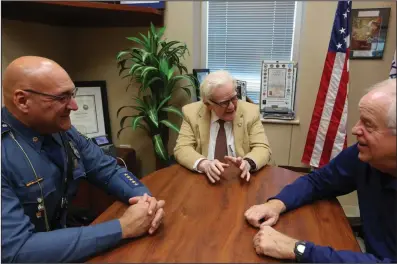  ?? (Arkansas Democrat-Gazette/Thomas Metthe) ?? Arkansas State Police Public Informatio­n Officer Bill Sadler (center) talks with Maj. Forrest Marks (left) and Col. Bill Bryant on Wednesday at the Arkansas State Police headquarte­rs in Little Rock.