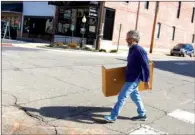  ?? MATT JOHNSON/CONTRIBUTI­NG PHOTOGRAPH­ER ?? Chris Adams moves shelving from The Sharing Shoppe’s old location to the new one, which is at 111 W. Arch St. in Searcy. The new store will open March 21.