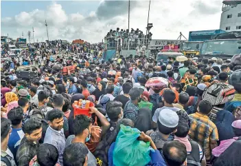  ?? —AFP ?? People crowd to board a ferry as authoritie­s ordered a new lockdown to contain the spread of the Coronaviru­s in Munshiganj in Bangladesh on Sunday.