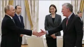  ?? AP PHOTO/ALEXANDER ZEMLIANICH­ENKO ?? Russian President Vladimir Putin, left, shakes hands with U.S. National security adviser John Bolton during their meeting in the Kremlin in Moscow, Russia on Tuesday.