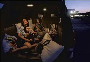  ?? JOHN RAOUX/AP ?? Lisa DiFlorio, a regular customer, watches a movie with her children at the Silver Moon Drive-In in 2008.