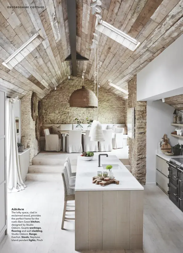  ??  ?? Kitchen
The lofty space, clad in reclaimed wood, provides the perfect frame for the rustic Barn Sawn kitchen, designed by Studio
Osborn. Quartz worktops,
flooring and wall cladding, Studio Osborn. Range, Everhot. Stools, Neptune.
Island pendant lights, Pinch